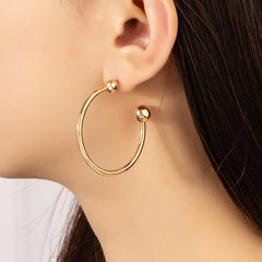 Elegant 18K gold-plated ball end huggie earrings, showcasing a stunning gold hoop design for a chic look.