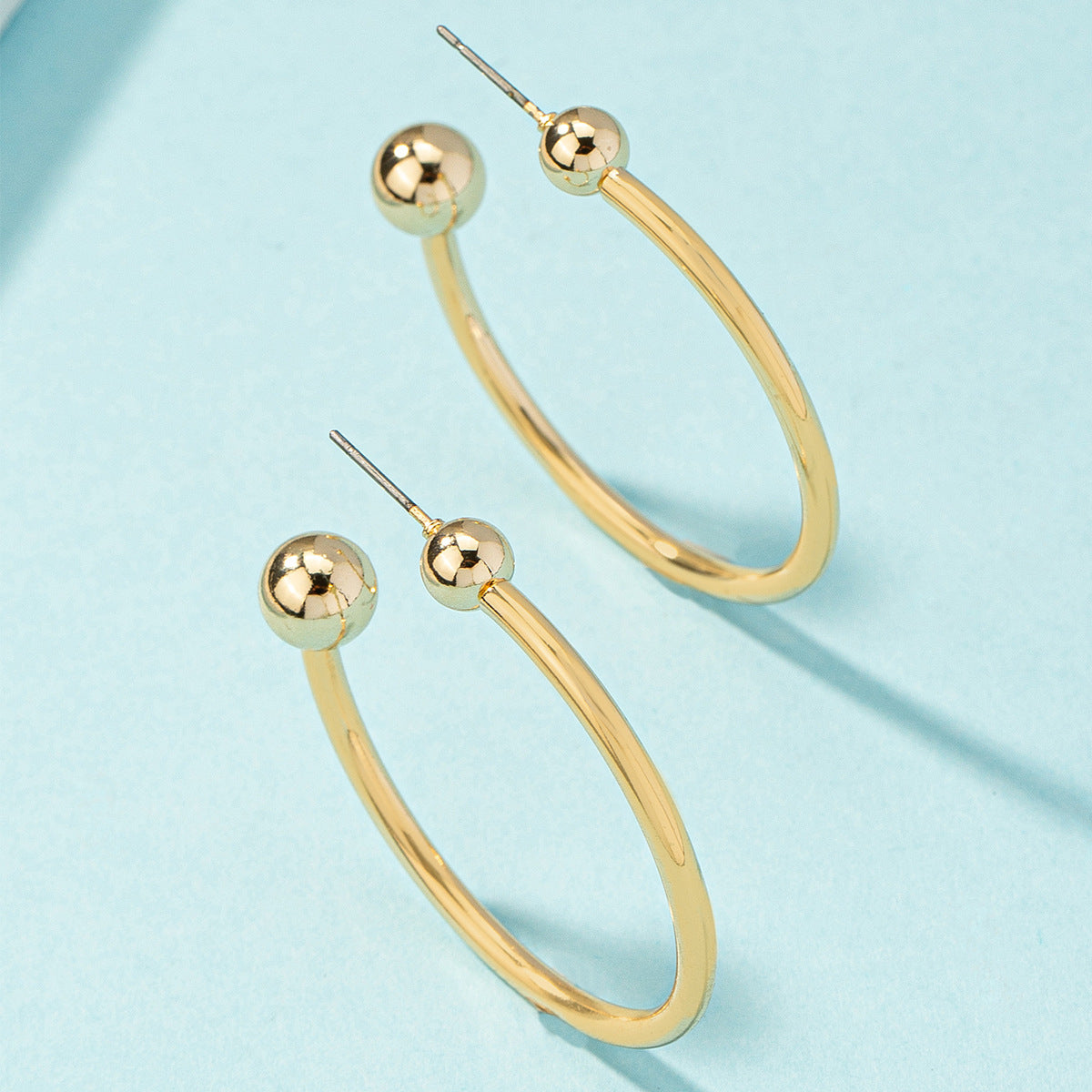 Dazzling 18K gold-plated huggie earrings with ball ends, a must-have for elevating your jewelry collection.