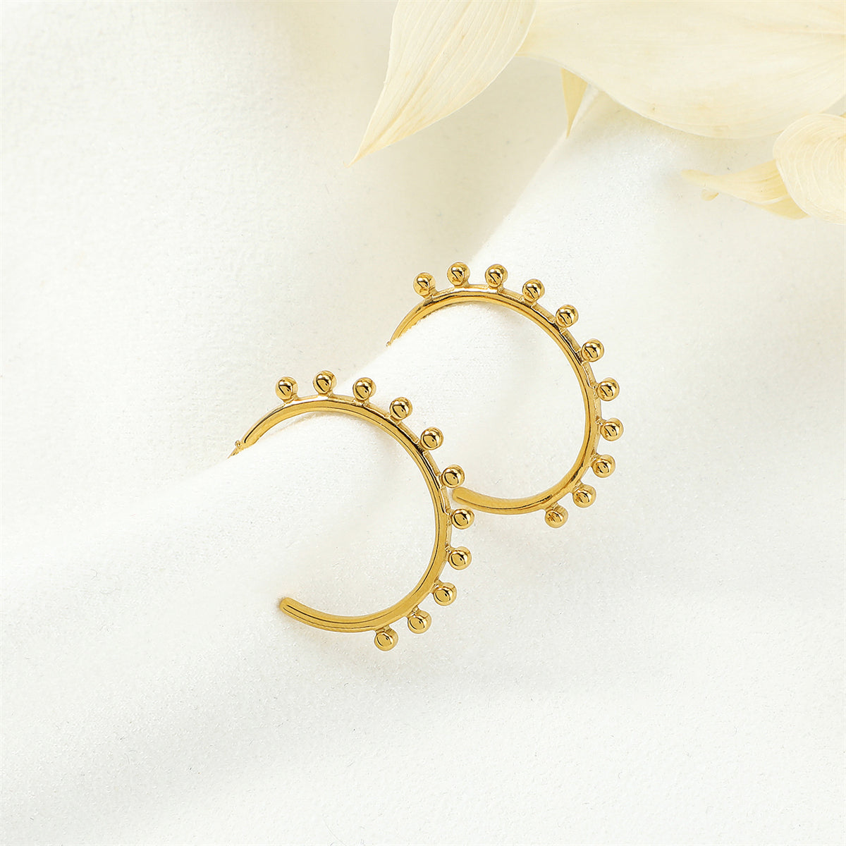 Elegant 18K gold-plated huggie earrings adorned with delicate beads, perfect for adding a touch of sophistication to any outfit.