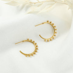 Dazzling 18K gold-plated huggie earrings embellished with tiny beads, perfect for enhancing your jewelry collection with elegance.