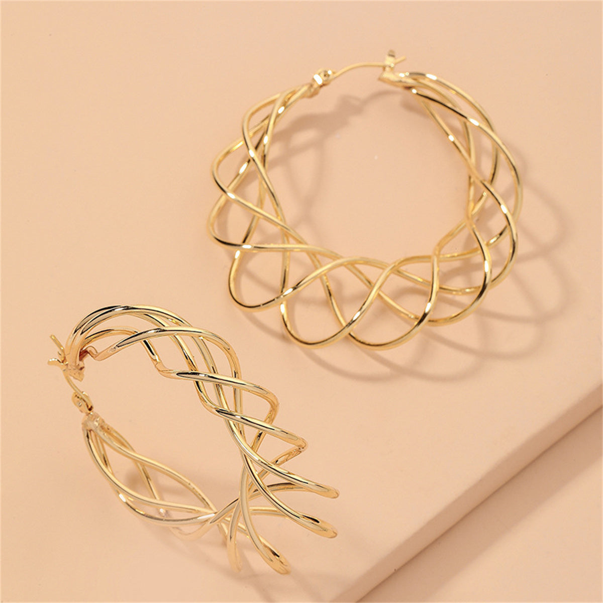 Stunning 18K gold-plated abstract nest hoop earrings, designed to elevate your style with their unique and chic look.