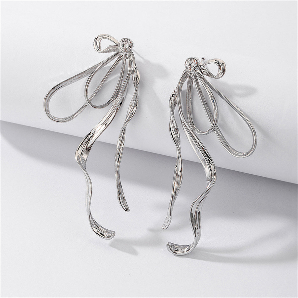 Cubic Zirconia and Silver-Plated Twist Bow Drop Earrings, silver drop earrings for women, everyday style, detail close-up