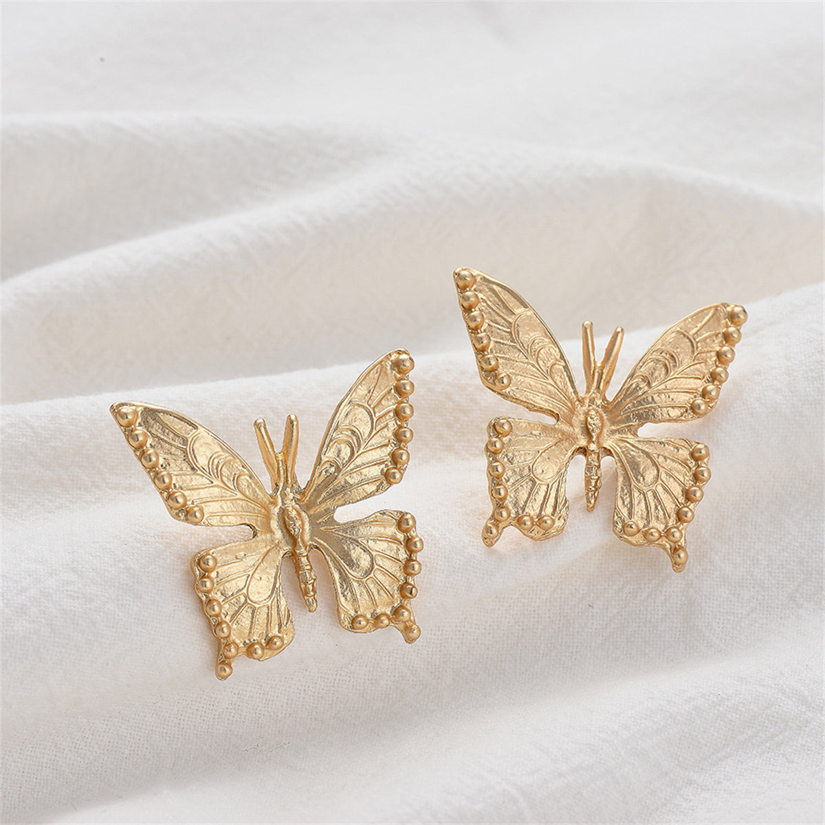 Stunning 18K gold-plated butterfly stud earrings featuring delicate small diamonds, ideal for a chic and sophisticated look.