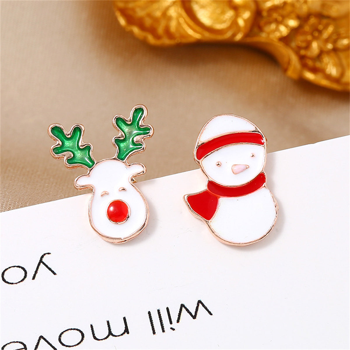 Adorable 18K gold-plated earrings showcasing multicolor snowman and reindeer, ideal for adding holiday cheer.