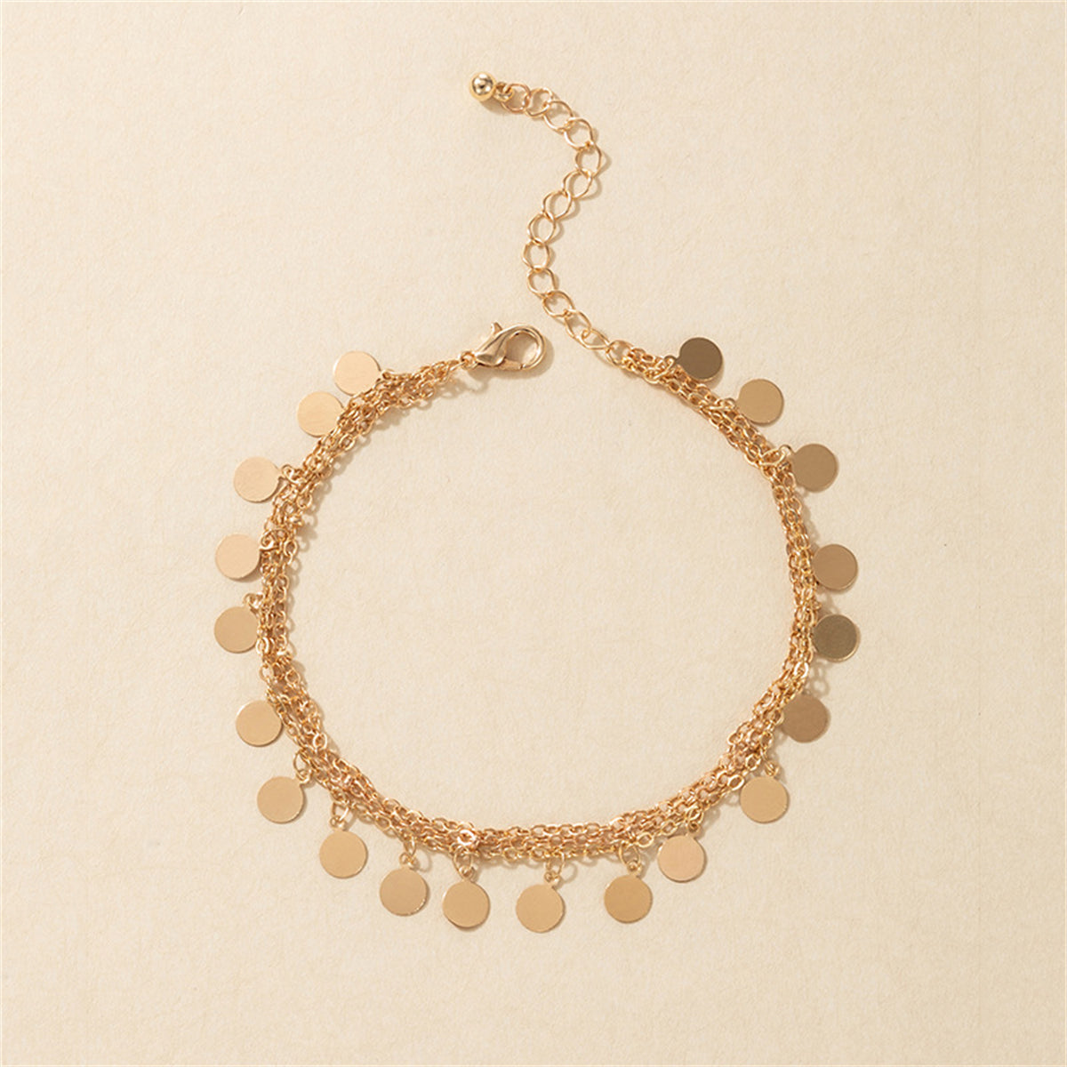 Beautifully crafted 18K gold-plated anklet showcasing a chain with small discs, perfect for adding elegance to any outfit.