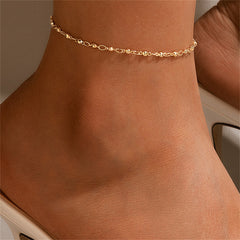 Elegant 18K gold-plated beaded chain anklet displayed on a pristine white surface, showcasing its luxurious shine.