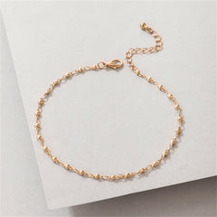 Stunning 18K gold-plated beaded chain anklet resting on a clean white background, highlighting its exquisite design.