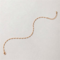 Beautiful 18K gold-plated beaded chain anklet elegantly placed on a white surface, emphasizing its radiant gold finish.
