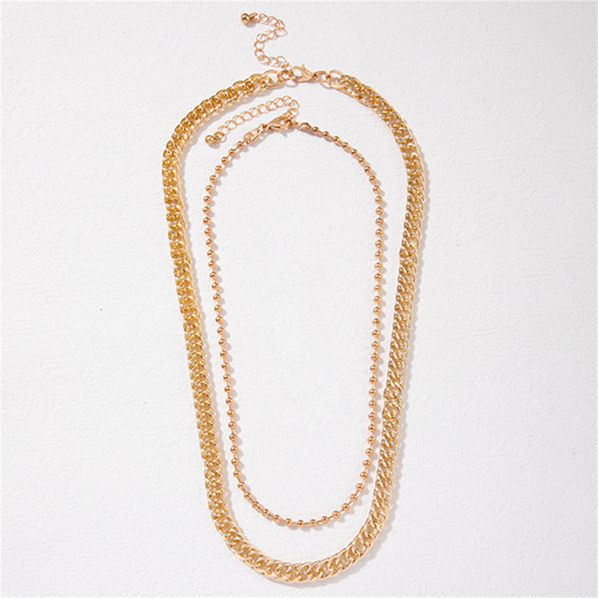 Stylish 18K gold-plated necklace set featuring a bead chain and curb chain in two sizes, perfect for any occasion.