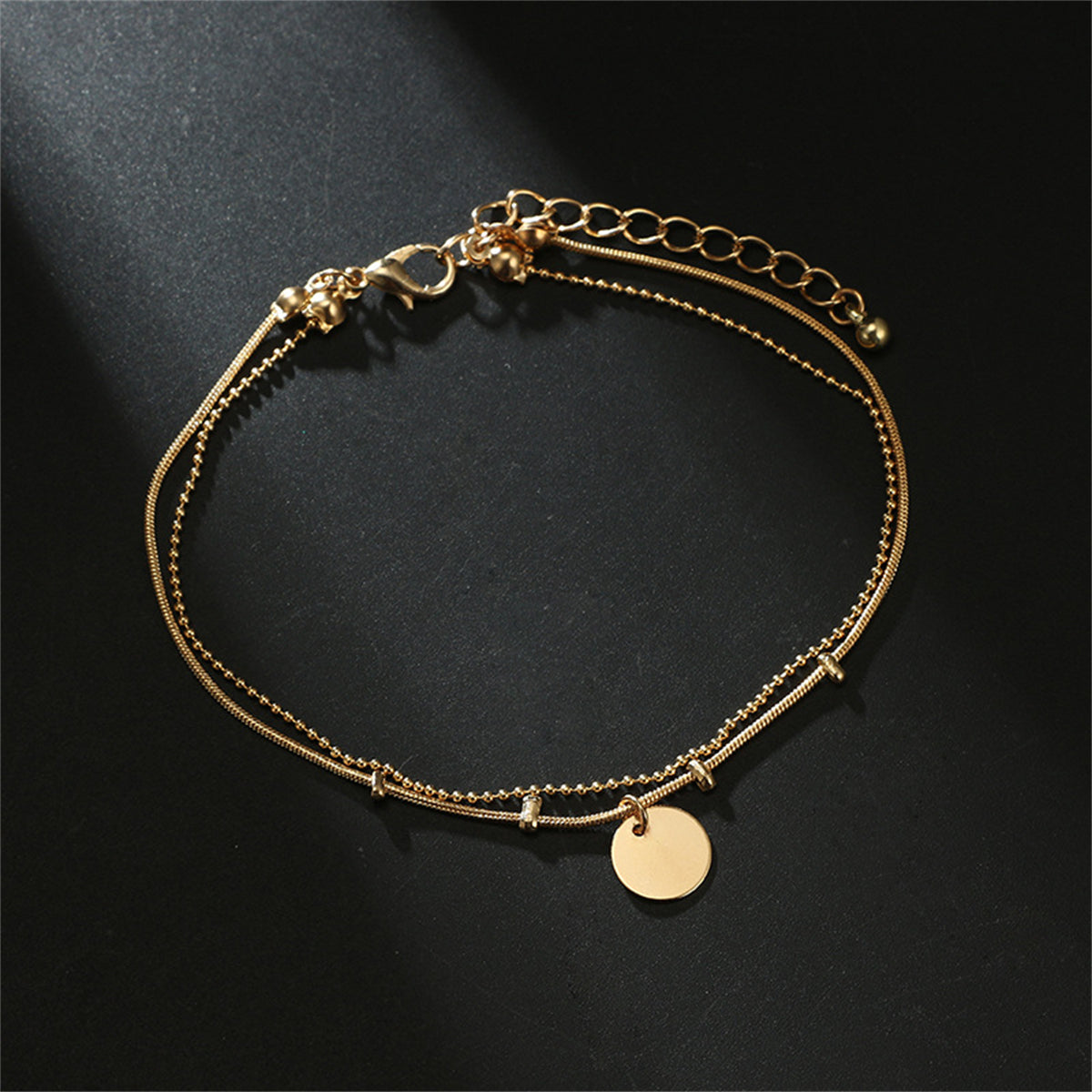 Stunning gold chain anklet with layered disc charms, perfect for adding a touch of elegance to any outfit.