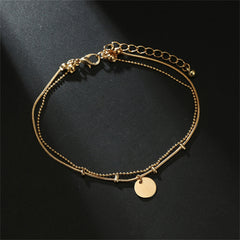 Stunning gold chain anklet with layered disc charms, perfect for adding a touch of elegance to any outfit.