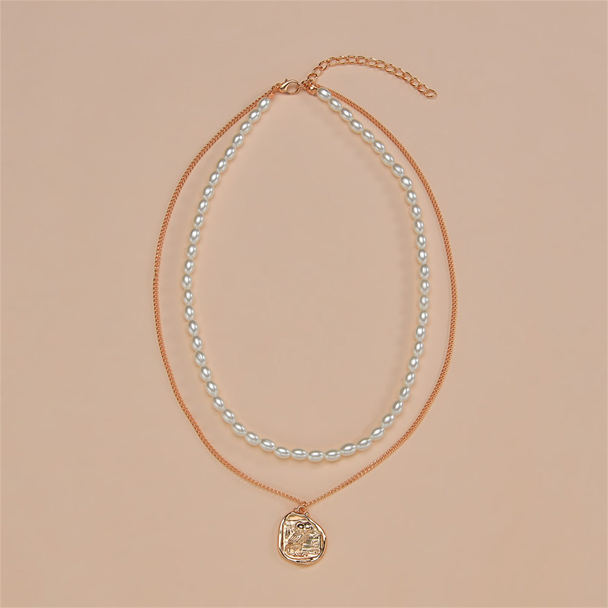 Layered necklace with an 18K gold-plated owl pendant, coin charm, and a stunning pearl chain for a refined look.