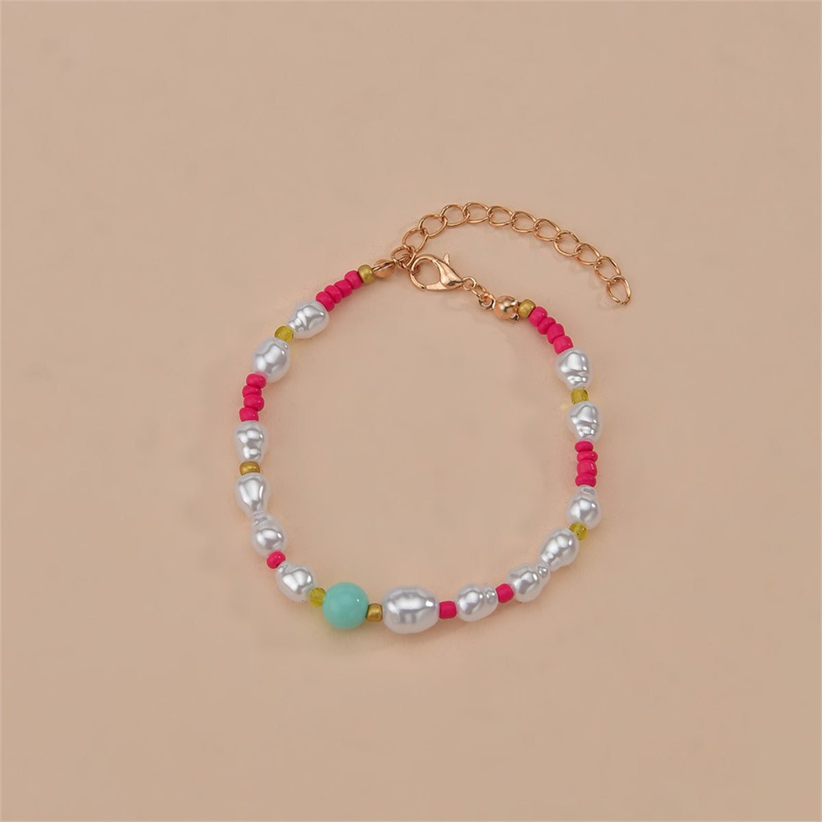 Elegant bracelet with pink and white beads, complemented by a gold chain, showcasing Howlite and Turquoise elements.