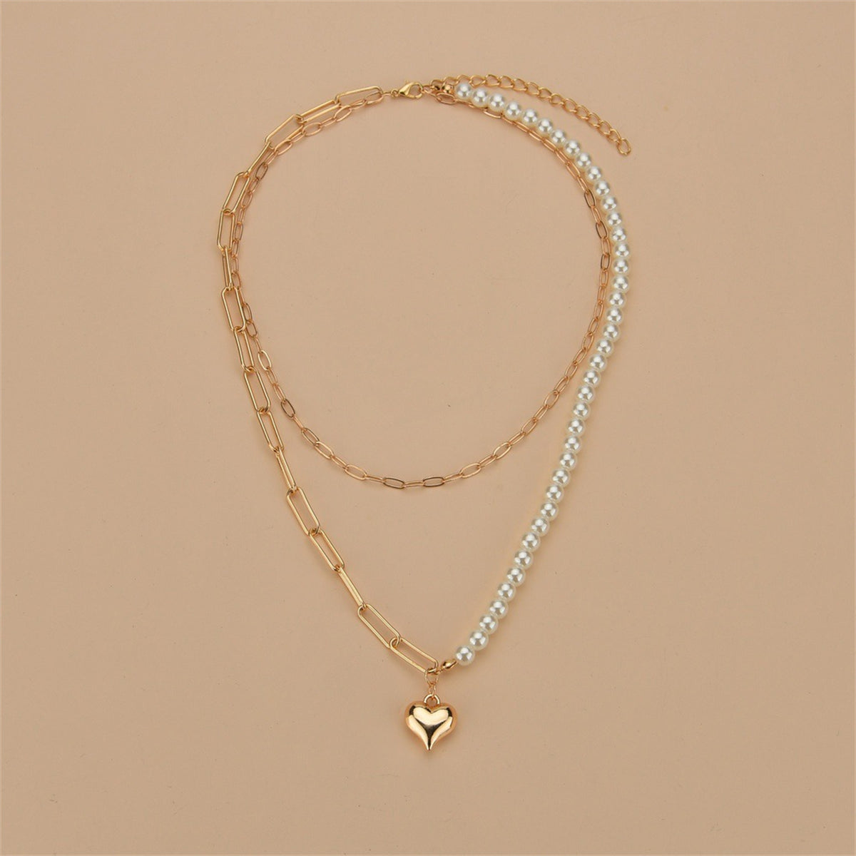 A sophisticated 18K gold-plated necklace with a heart charm and pearl, perfect for adding elegance to any outfit.
