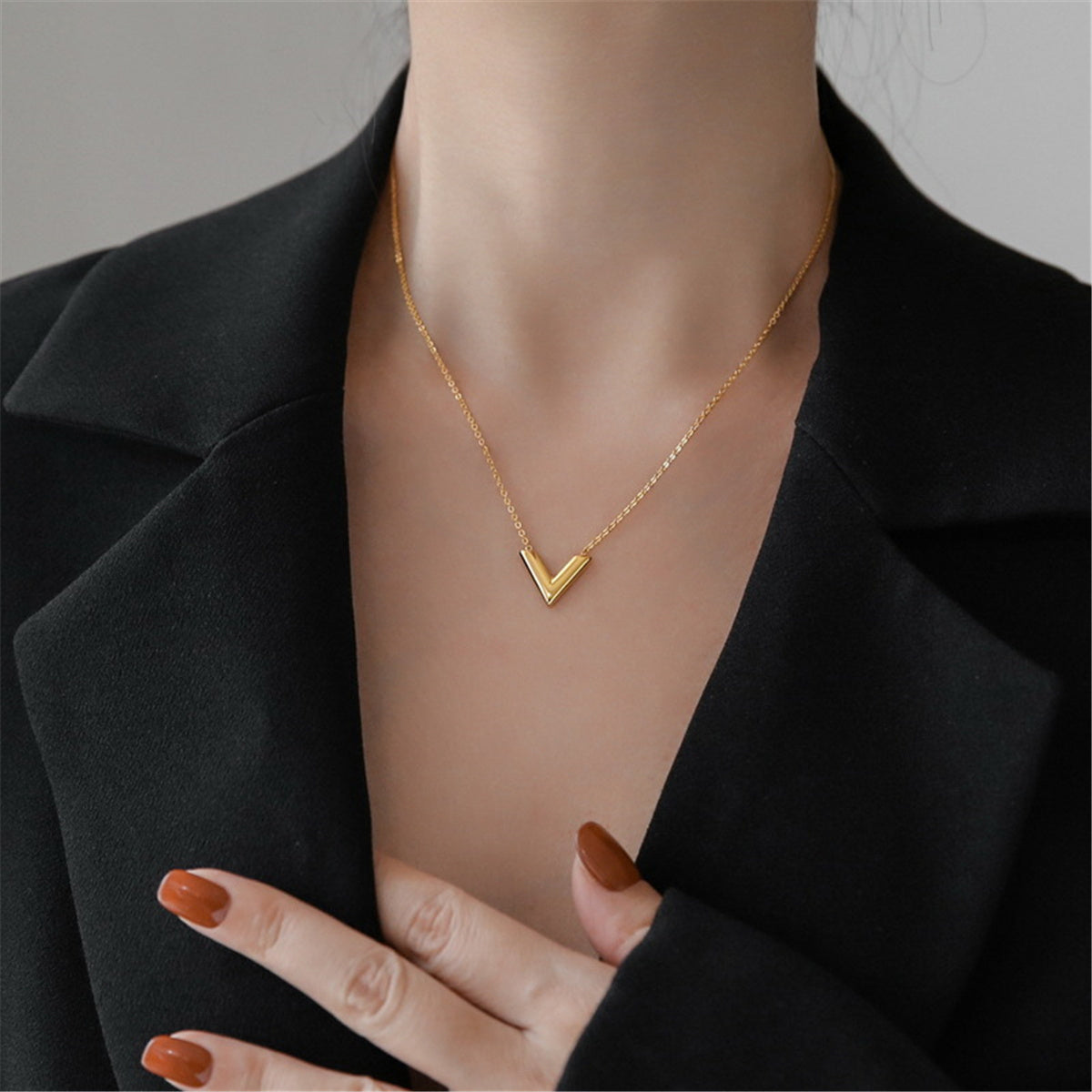 Dazzling 18K gold-plated 'V' pendant necklace, perfect for making a statement in any ensemble.