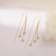 Chic 18K gold-plated threader earrings adorned with two beautiful beaded balls, ideal for a fashionable statement.