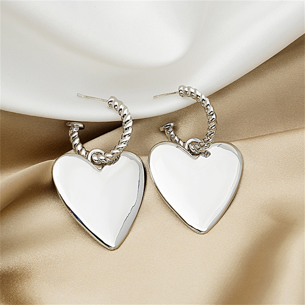Silver-Plated Heart Huggie Earrings, silver huggie earrings, dainty minimalist design, detail close-up