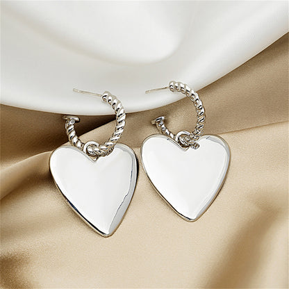 Silver-Plated Heart Huggie Earrings, silver huggie earrings, dainty minimalist design, detail close-up
