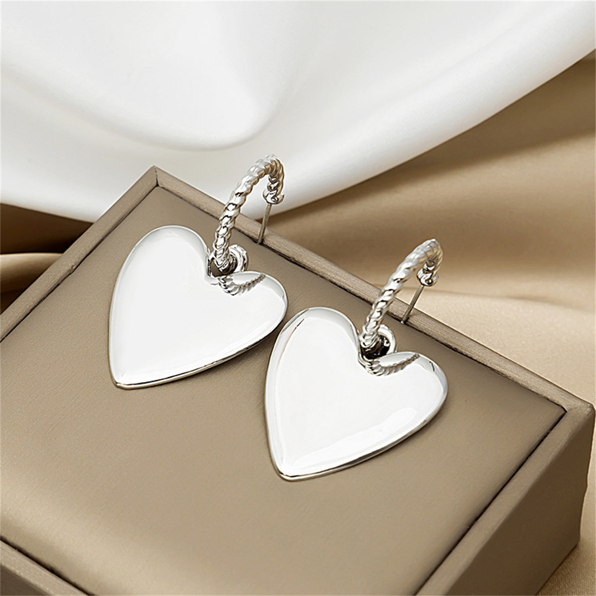 Silver-Plated Heart Huggie Earrings, silver huggie earrings, dainty minimalist design, front view