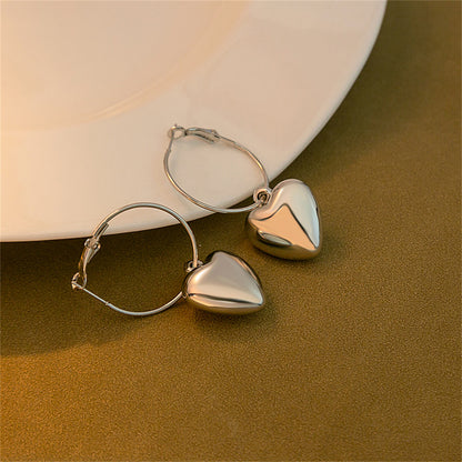 Silver-Plated Heart Huggie Earrings, silver huggie earrings, vintage-inspired design, side view
