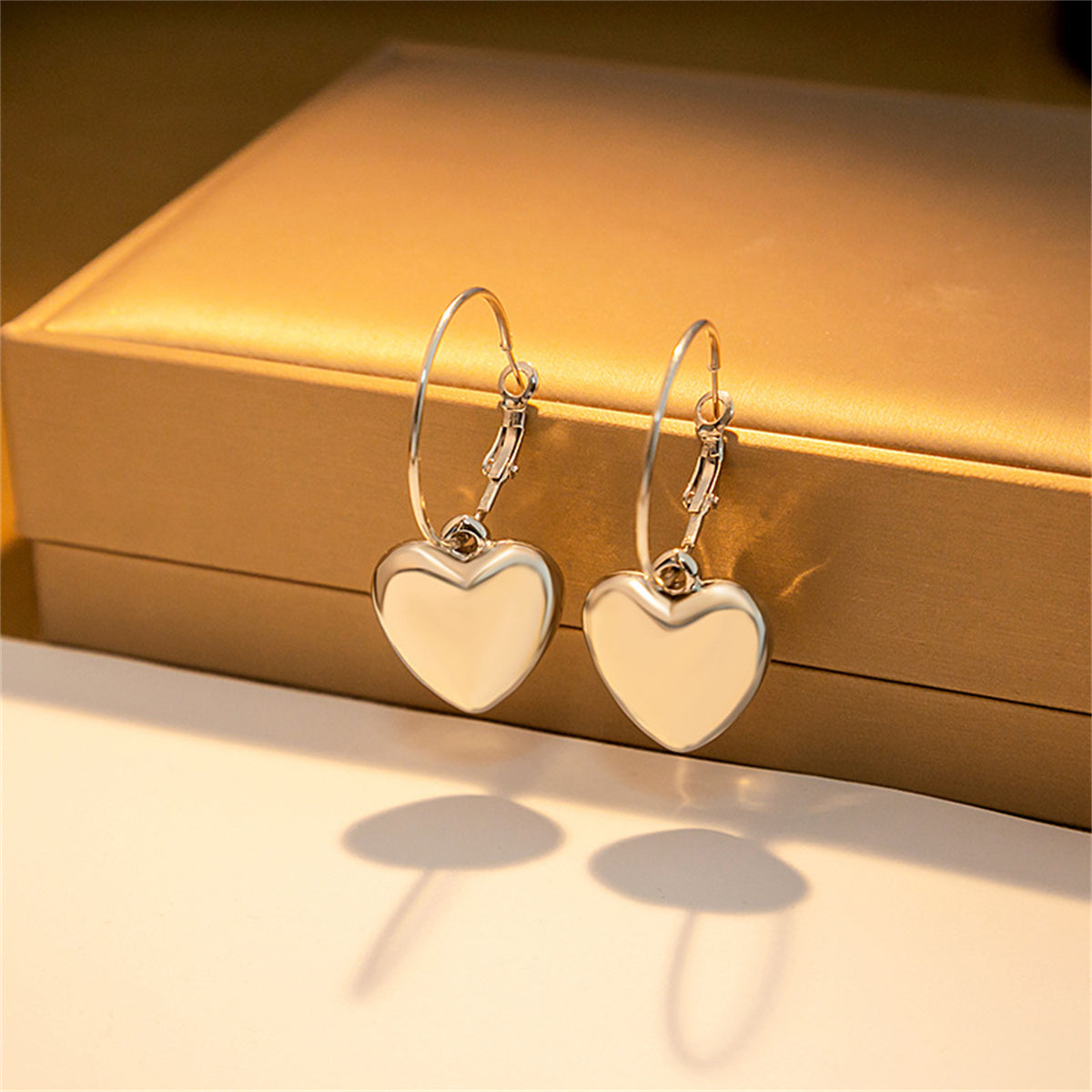 Silver-Plated Heart Huggie Earrings, silver huggie earrings, vintage-inspired design, detail close-up
