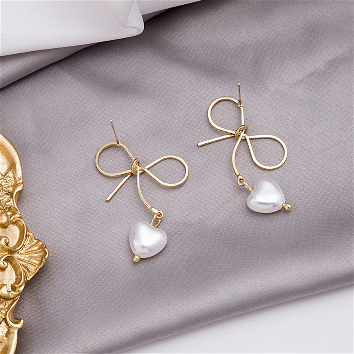 Pearl and 18K Gold-Plated Bow and Heart Drop Earrings, gold drop earrings for women, vintage-inspired design, detail close-up
