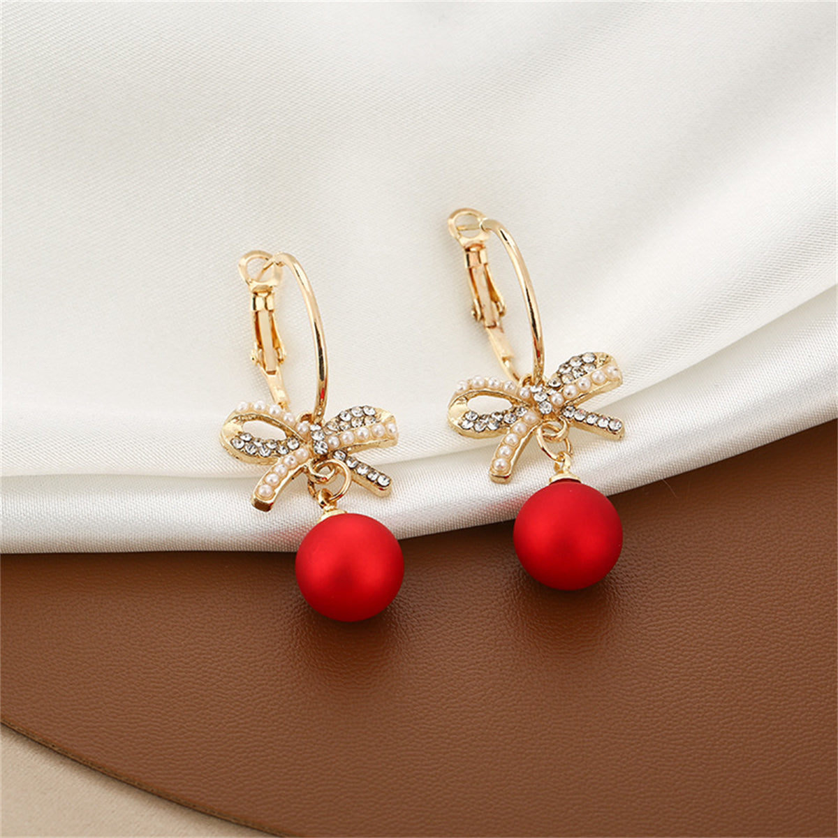 Red Resin and Pearl Cubic Zirconia Bow Huggie Earrings, huggie earrings, botanical inspired, front view