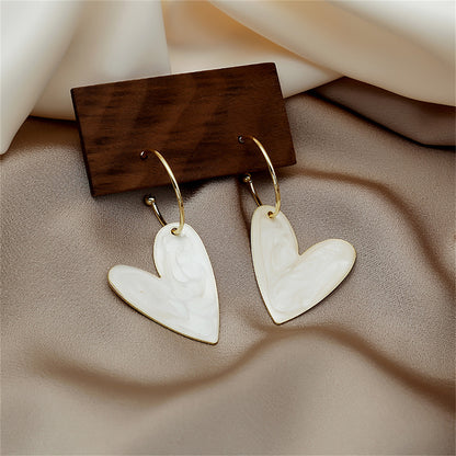 White Enamel and 18K Gold-Plated Heart Huggie Earrings, gold huggie earrings, dainty minimalist design, side view