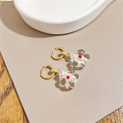 Clear Resin and 18K Gold-Plated Flower Huggie Earrings, gold huggie earrings, vintage-inspired design, detail close-up