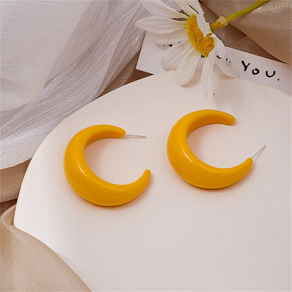 Orange Resin and Silver-Plated Crescent Huggie Earrings, silver huggie earrings, botanical inspired, front view