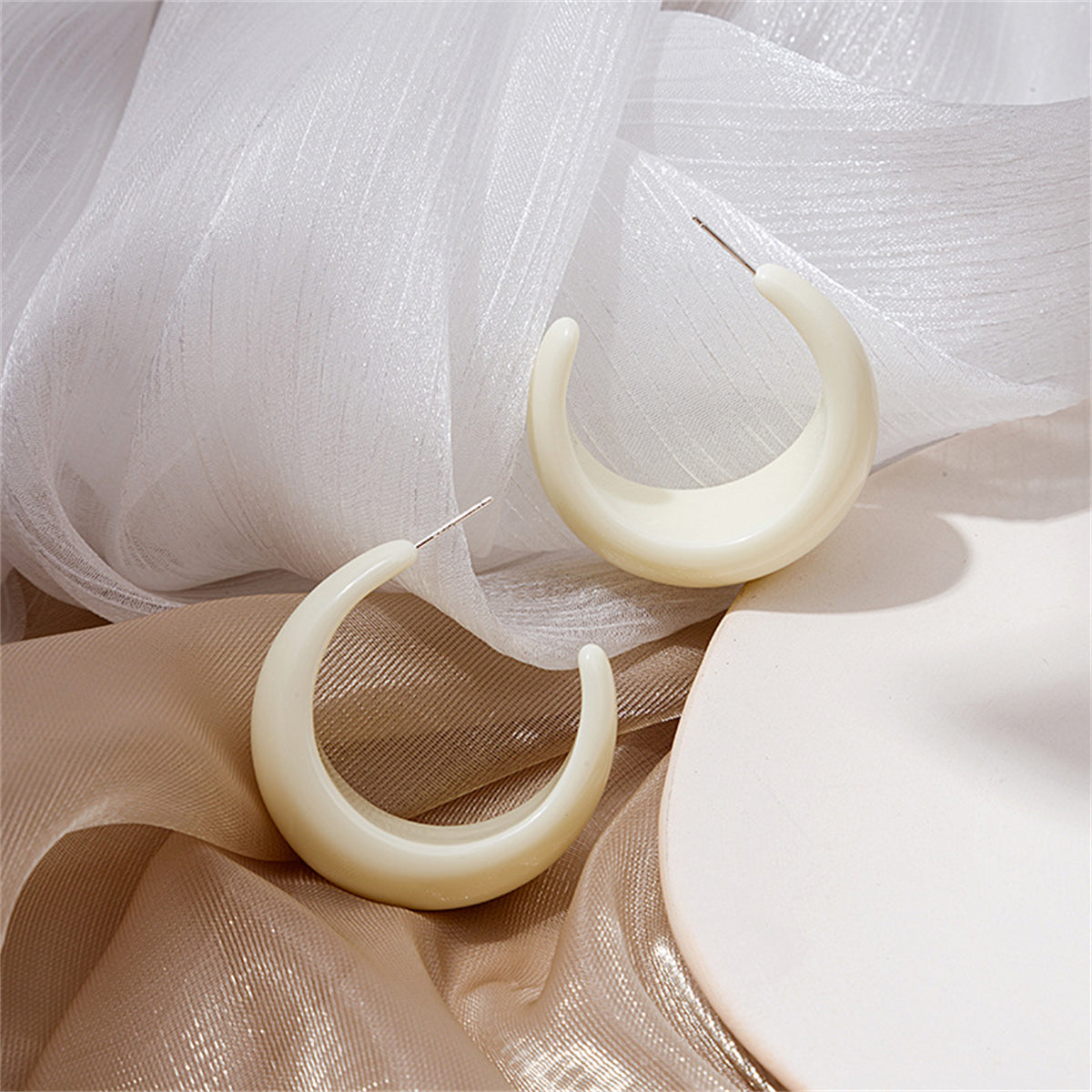 White Resin and Silver-Plated Crescent Huggie Earrings, silver huggie earrings, vintage-inspired design, front view