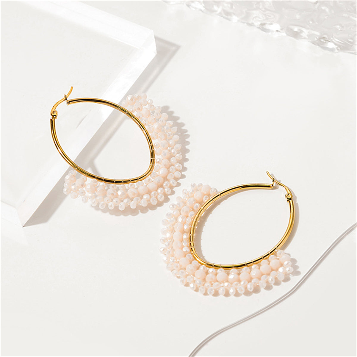 White Acrylic and 18K Gold-Plated Oval Huggie Earrings, gold huggie earrings, vintage-inspired design, front view