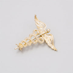 Exquisite gold caduceus brooch adorned with angel wings and a snake, embodying the spirit of healing and medical professionalism.