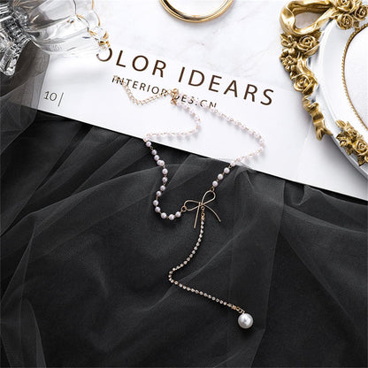 Pearl and Cubic Zirconia Bow Lariat Necklace, pendant necklace for women, vintage-inspired design, front view