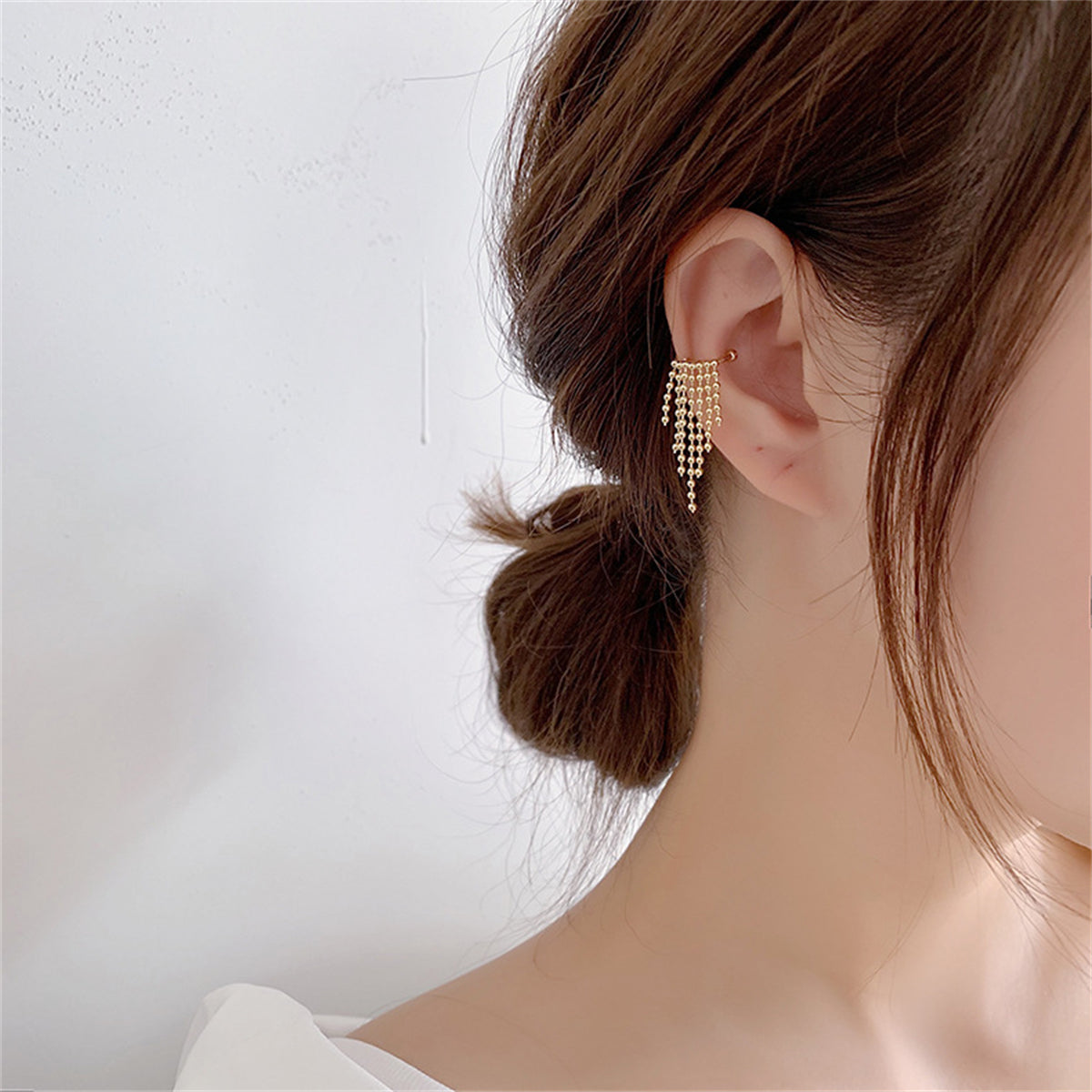 Fashion-forward 18K gold-plated ear cuff with charming beads, perfect for making a bold statement in your accessory game.