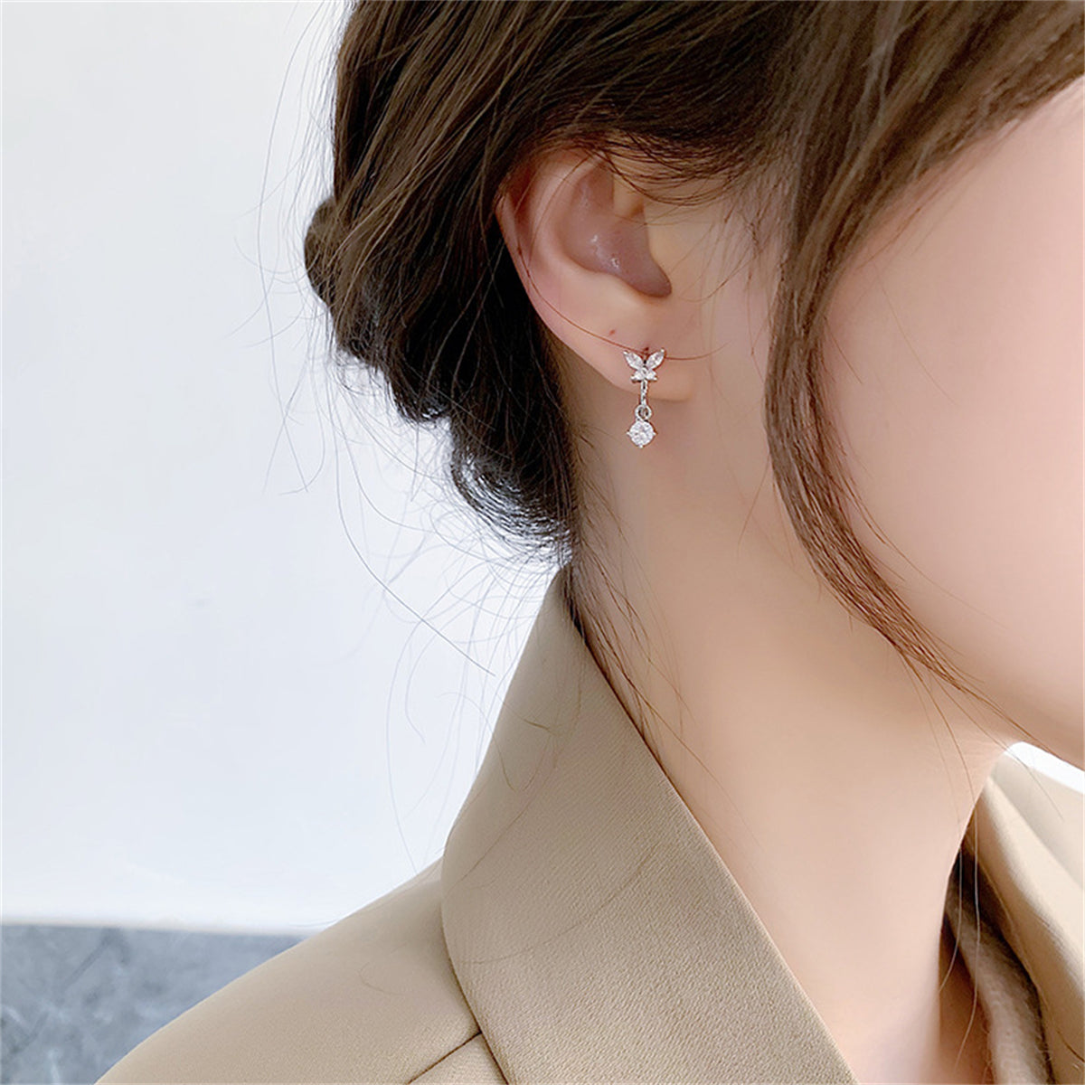 Cubic Zirconia and Silver-Plated Butterfly Huggie Earrings, silver huggie earrings, dainty minimalist design, front view