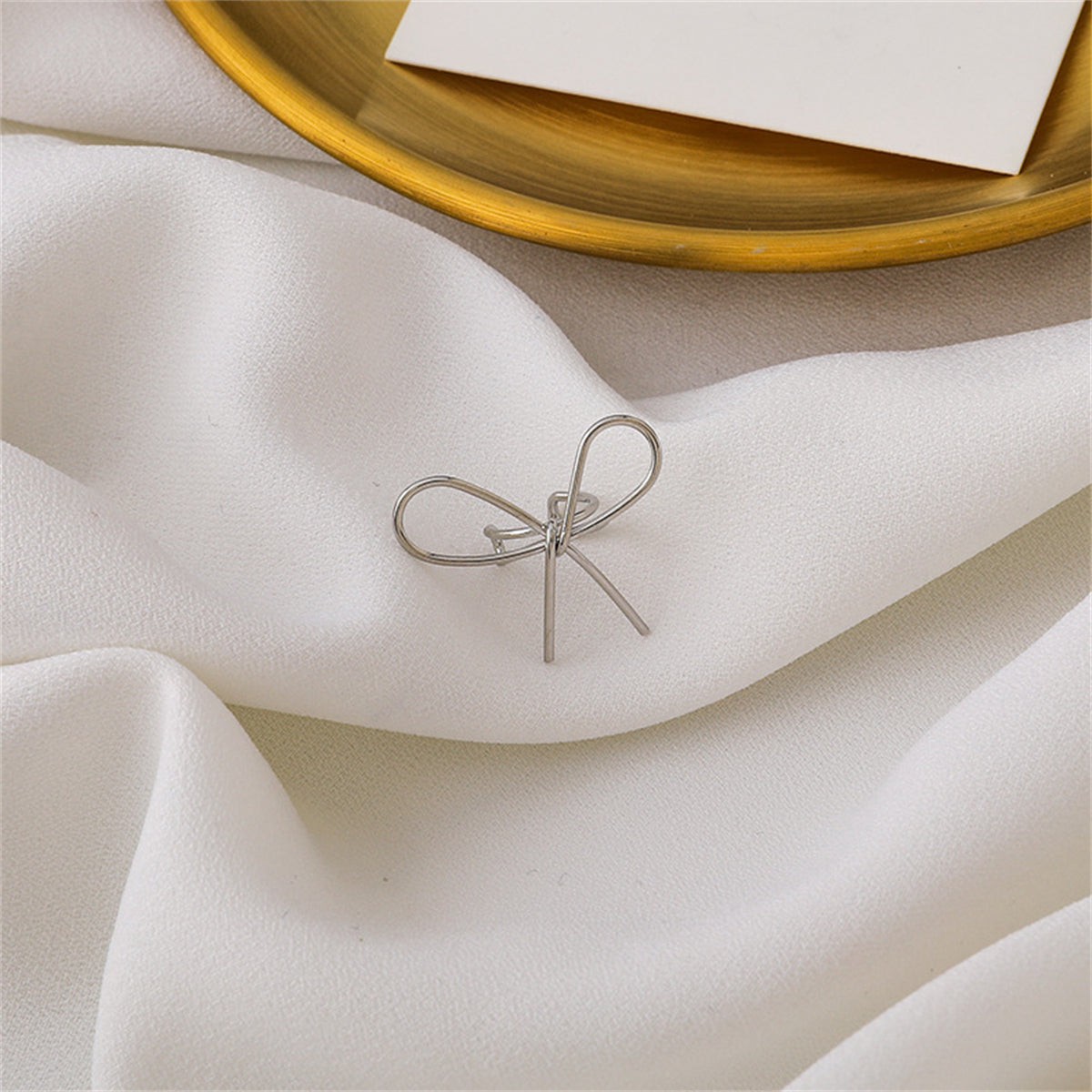 Silver-Plated Bow Ear Cuff, silver stud earrings for women, dainty minimalist design, detail close-up