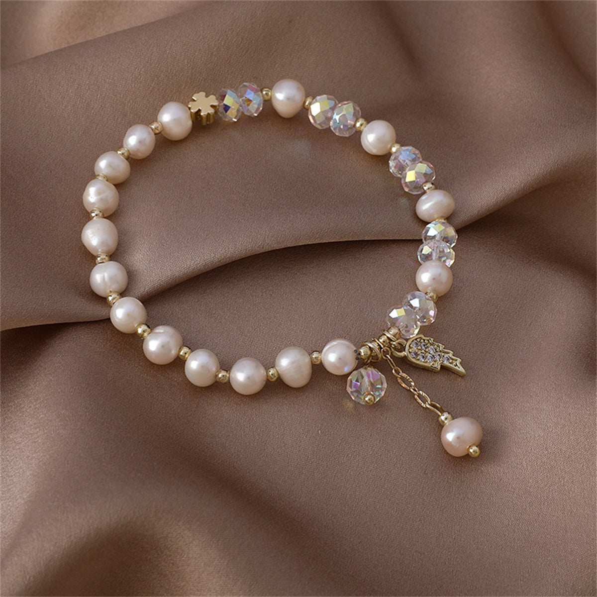 Pearl and Cubic Zirconia 18K Gold-Plated Wing Charm Stretch Bracelet, gold bracelet for women, everyday style, front view