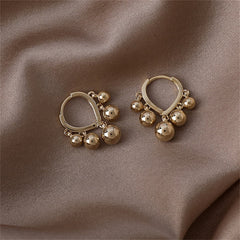 Elegant 18K gold-plated hoop earrings featuring ball tassels for a chic and stylish look. Perfect for any occasion.
