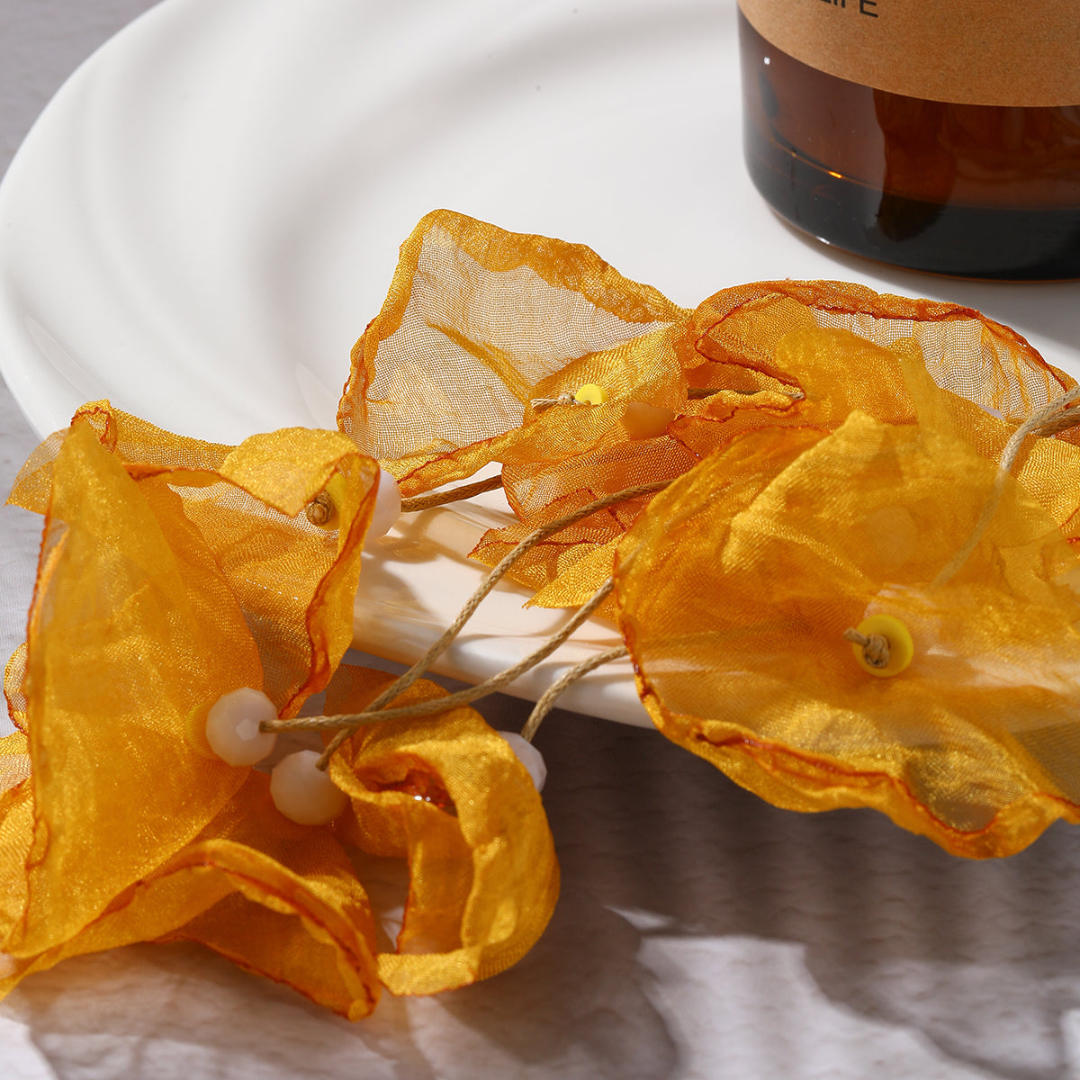 Beautiful yellow flower earrings made of polyester, showcasing five petals and complemented by gold-plated hooks.