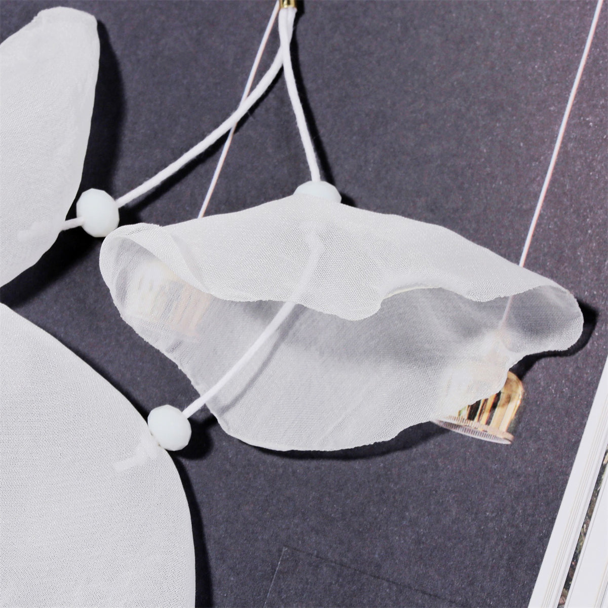 Charming white flower earrings with five petals, designed in polyester and finished with gold-plated hooks for elegance.