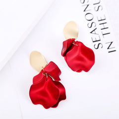 Stunning red acrylic earrings shaped like flowers, adorned with 18K gold-plated accents for a luxurious touch.