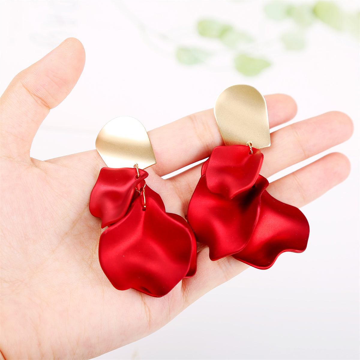 Vibrant red acrylic four-petal earrings with luxurious 18K gold-plated accents, perfect for a stylish accessory.