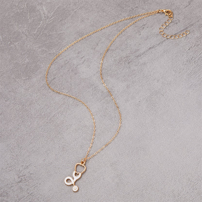 Enamel and 18K Gold-Plated Stethoscope Pendant Necklace, gold pendant necklace for women, detail close-up