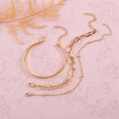 Two luxurious gold chains alongside a chic bracelet on a white surface, highlighting the exquisite 18K gold-plated craftsmanship.