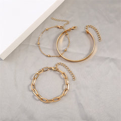 An elegant display of two gold chains and a bracelet on a white surface, emphasizing the beauty of 18K gold-plated jewelry.