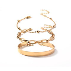 A stunning arrangement of two gold chains and a bracelet on a white background, featuring an 18K gold-plated finish.