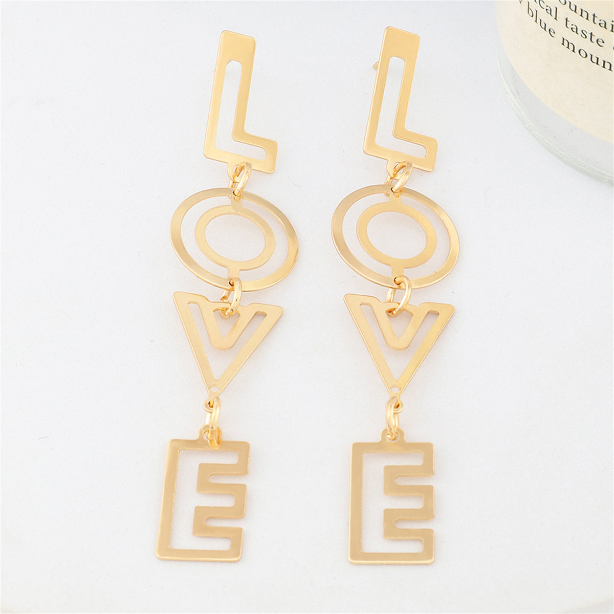 Chic 18K gold-plated openwork drop earrings spelling 'Love', a stylish accessory to celebrate love and elegance.