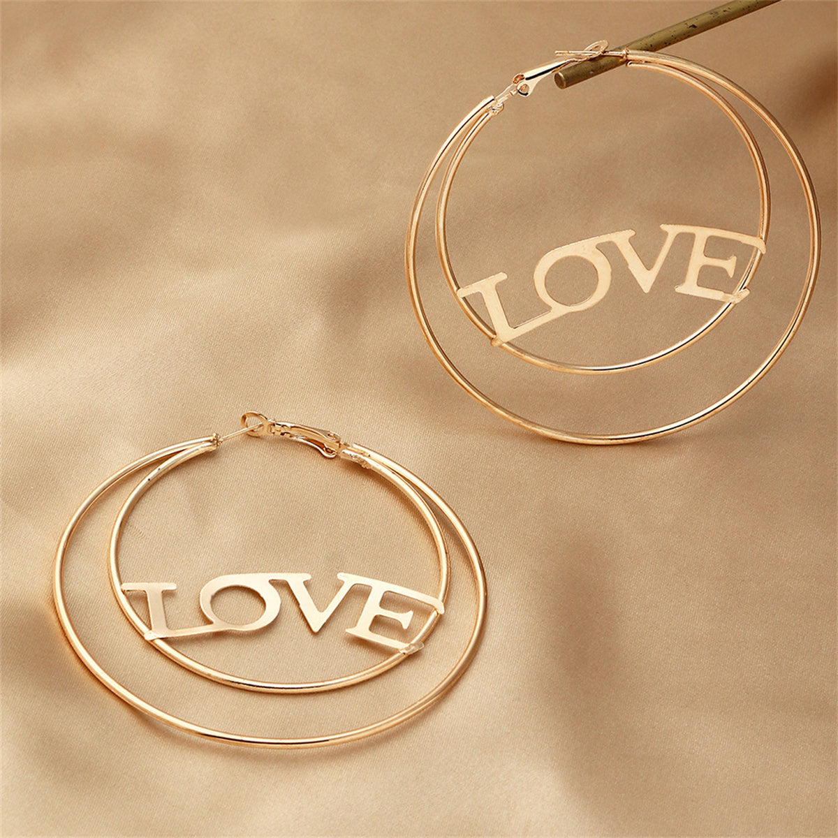 Chic 18K gold-plated openwork hoop earrings featuring a 'Love' design, a must-have for any jewelry collection.