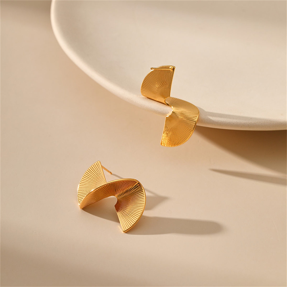 Stylish 18K gold-plated earrings with a dynamic wave design, an exquisite choice for enhancing your jewelry collection.